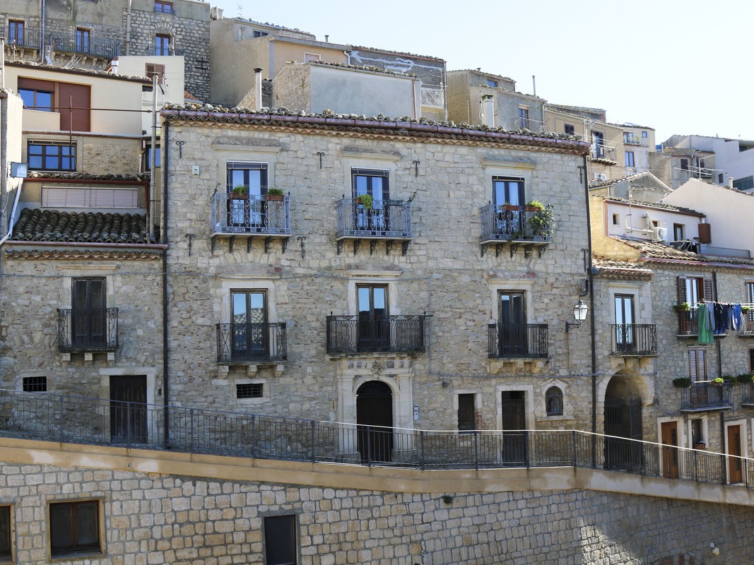 Image of the historical residence with balconies in Sicily