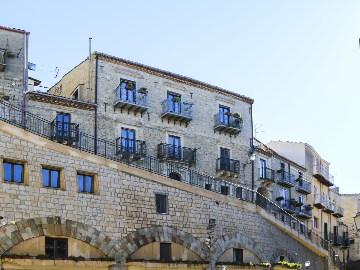 Image of the historical residence with balconies in Sicily