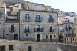 Image of a old house in Sicily with balconies and beautiful entrance in a small town