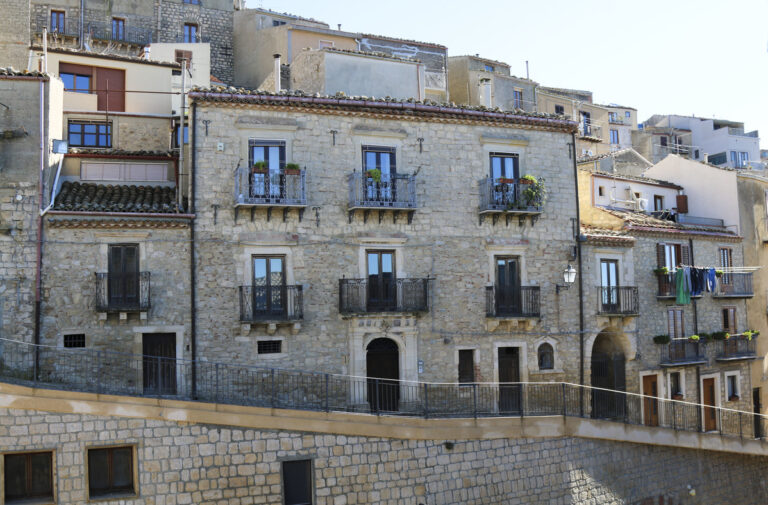 Image of a old house in Sicily with balconies and beautiful entrance in a small town