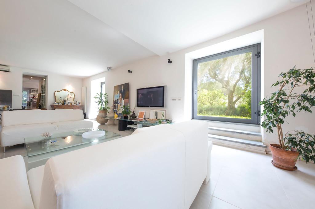Image of a living room with a window looking at the garden