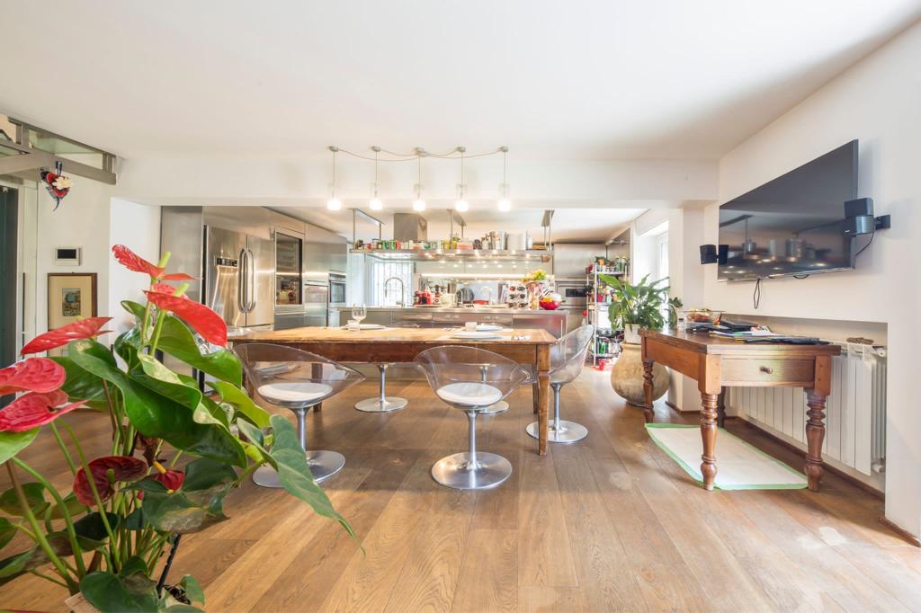 Image of a big kitchen with a table and chairs