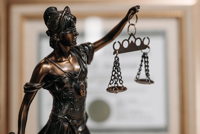 Image of a bronze statue of woman holding a scale