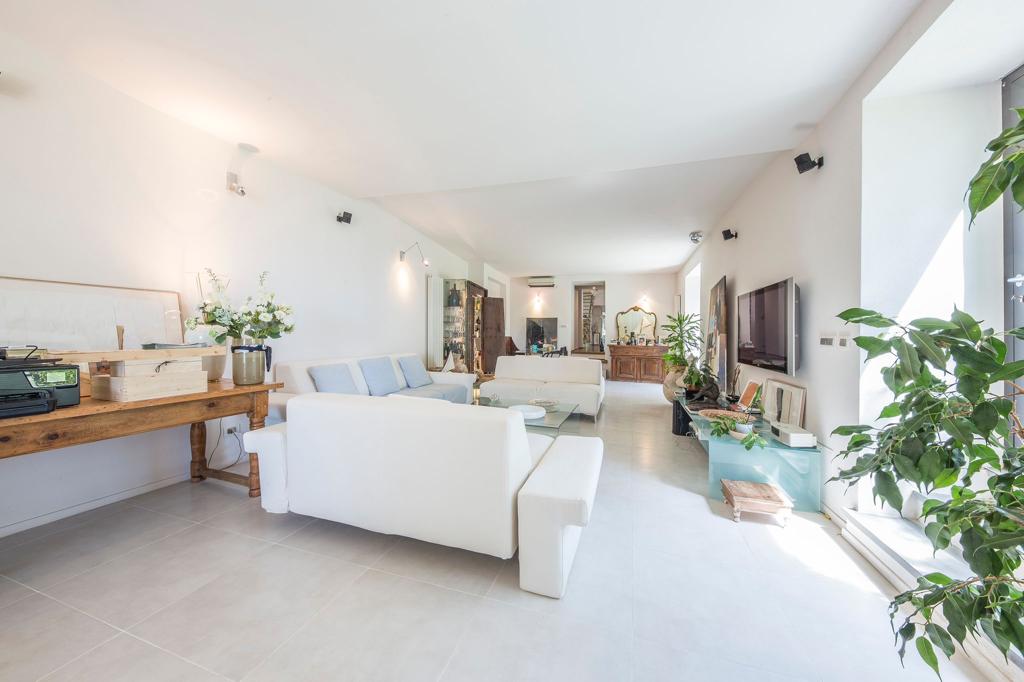 Image of a living room with white couches and modern furniture