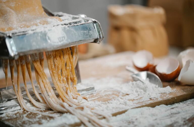 Image of a pasta making machine with eggs and flour