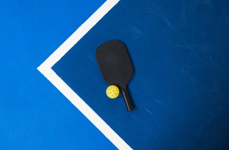 Image of a pickleball racket and ball